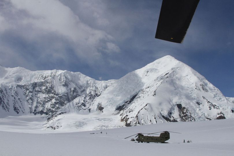 A U.S. Army Chinook helicopter, the type used for high-elevation rescues, stages on the Kahiltna Glacier below Denali in Alaska.  (Associated Press)