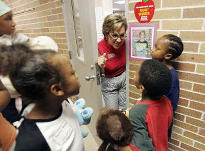 
Back to school: Hull Elementary music teacher Barbara Alvarado on Thursday greets children who were evacuated from the New Orleans area due to Hurricane Katrina as they toured the school in San Antonio. About 60 students are expected to start their first day of classes at the school today. 
 (Associated Press / The Spokesman-Review)