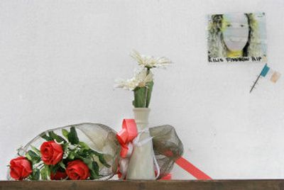 
Flowers are left in memory of a tsunami victim Saturday at the Wall of Remembrance on the outskirts of Phuket, Thailand.  
 (Associated Press / The Spokesman-Review)