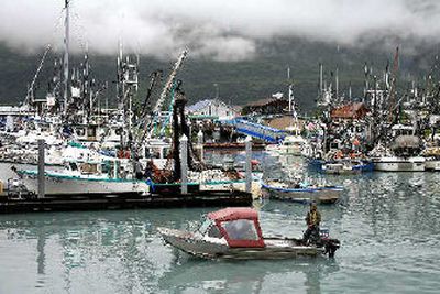 
A boat motors out of the harbor in Valdez, Alaska, past docks with commercial fishing boats mixed in with personal boats. Between one-third and one-half of Valdez's work force have jobs related to the marine terminal, but none are as high-paying as the Alyeska Pipeline Service Co. 
 (Associated Press / The Spokesman-Review)