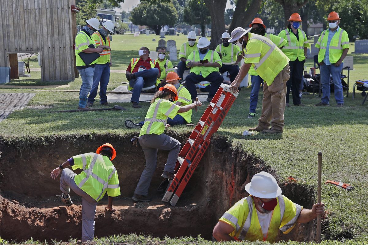 FILE - In this July 14, 2020, file photo, workers climb out of the excavation site as work continues on a potential unmarked mass grave from the 1921 Tulsa Race Massacre, at Oaklawn Cemetery in Tulsa, Okla. A second excavation begins Monday, Oct. 19, 2020, at a cemetery in an effort to find and identify victims of the 1921 Tulsa Race Massacre and shed light on violence that left hundreds dead and decimated an area that was once a cultural and economic mecca for African Americans. (Sue Ogrocki)