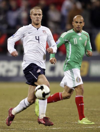 Associated Press Michael Bradley, left, brings ball upfield against Mexico’s Carlos Ochoa. (Associated Press / The Spokesman-Review)