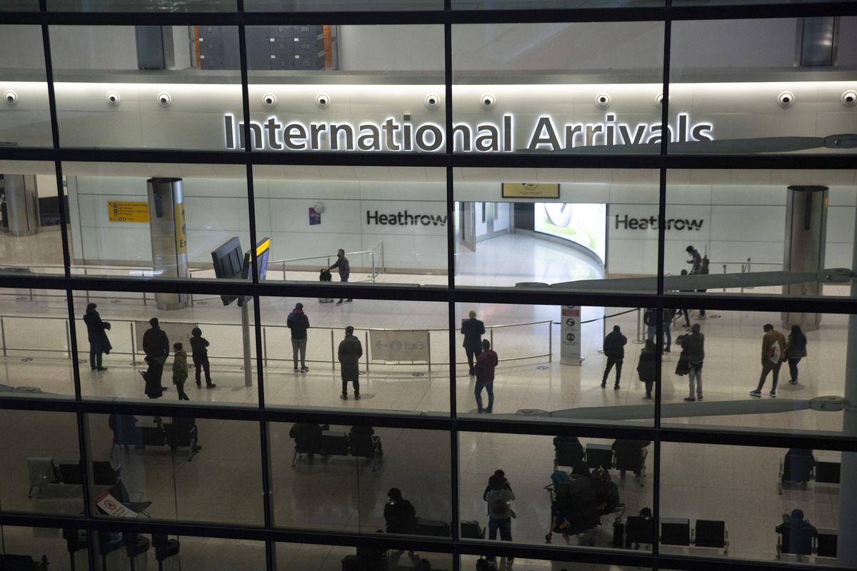 FILE - In this file photo dated Tuesday, Jan. 26, 2021, people in the International Arrivals area at Heathrow Airport in London, during England