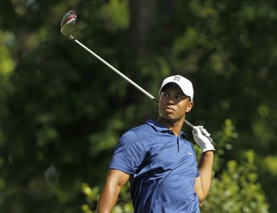 Tiger Woods studies his tee shot on the 15th hole during the second round.  (Associated Press)