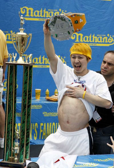 
Takeru Kobayashi holds the coveted Mustard Belt after winning the Nathan's Famous Hot Dog Eating Competition for the sixth straight time Tuesday in Coney Island, New York. 
 (Associated Press / The Spokesman-Review)