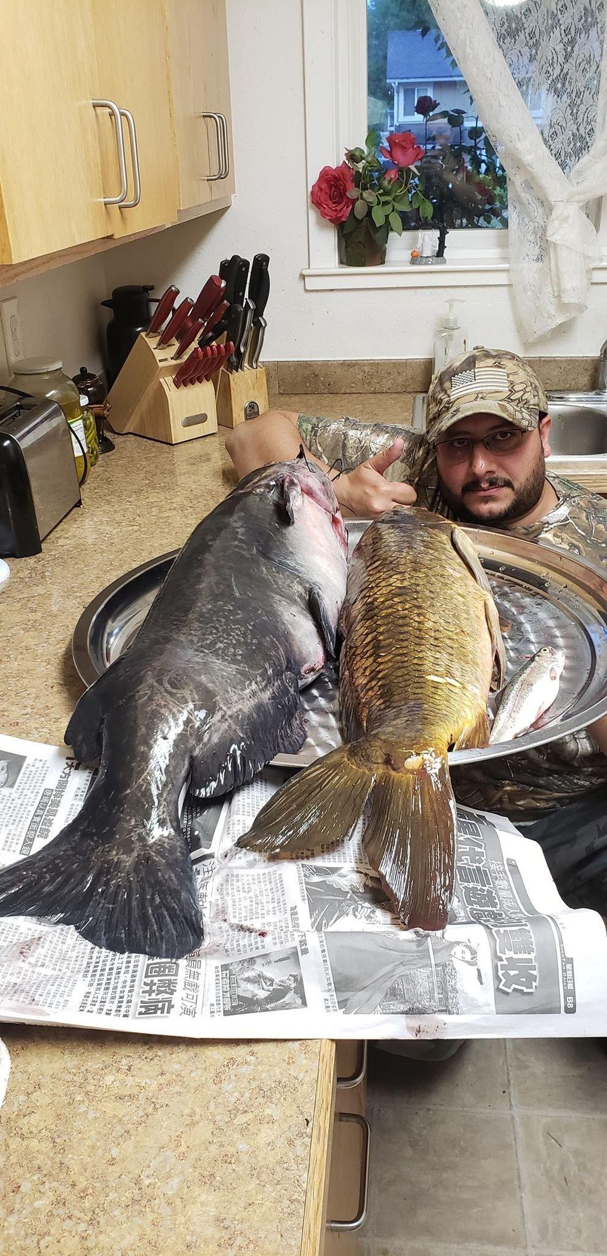 Ahmed Majeed shows off his catch of a huge carp and catfish on Saturday, June 9 at Green Lake. (Courtesy of / Ahmed Majeed)