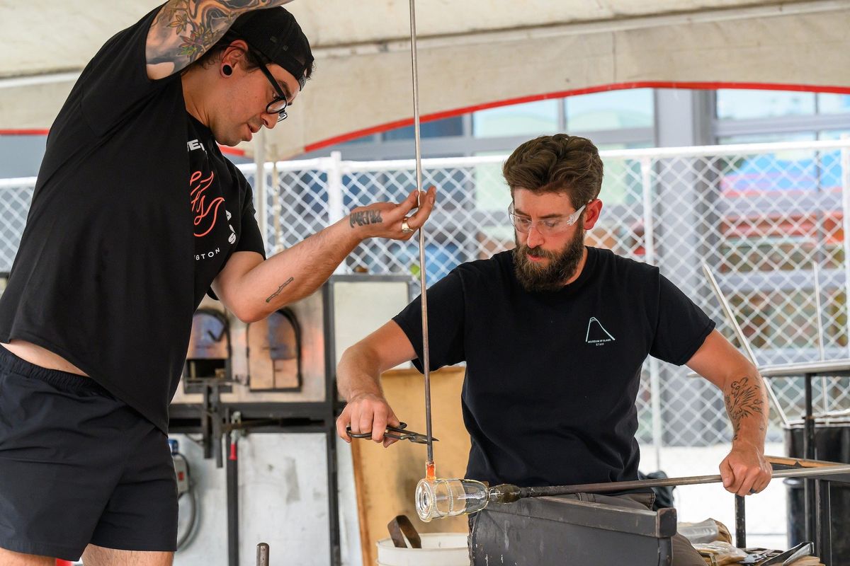 Ben Cobb and Conor McClellan give a glassblowing demonstration as part of the Museum of Glass Mobile Hot Shop outside of the Jordan Schnitzer Museum of Art at Washington State University on Aug. 30, 2023.   (Courtesy of Robert Hubner)