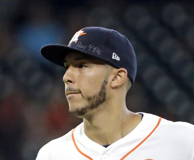 Houston Astros shortstop Carlos Correa wears messages on his cap for those affected by disasters in Mexico and Puerto Rico during the second inning of a baseball game Saturday, Sept. 23, 2017, in Houston. (David J. Phillip / Associated Press)