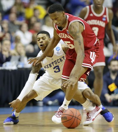 Kentucky guard Tyler Ulis, left, tries to steal the ball from Indiana forward Troy Williams during the second half of a second-round men's college basketball game in the NCAA Tournament. Indiana won 73-67. (Associated Press)