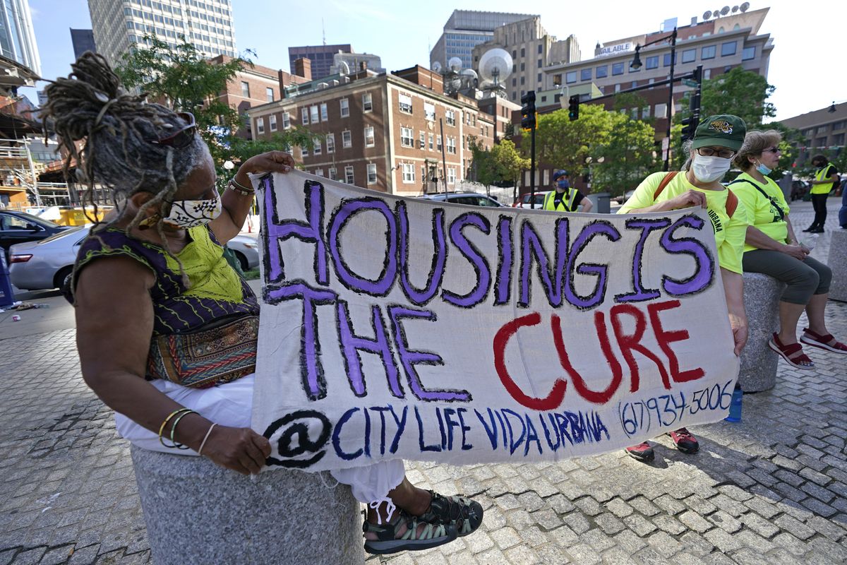 Protesters hold a sign during June 9 rally in Boston  (Elise Amendola)