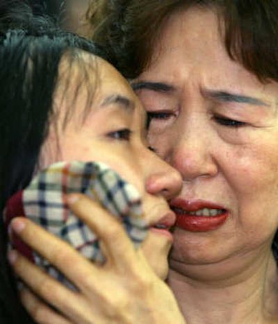 
Lee Sung-eun, left, one of the 19 released hostages from South Korea, meets with her mother after arriving at a hospital in Anyang today. Associated Press
 (Associated Press / The Spokesman-Review)