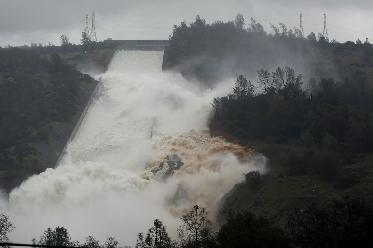 Water flows through a break in the wall of the Oroville Dam spillway, Thursday, Feb. 9, 2017, in Oroville, Calif. The torrent chewed up trees and soil alongside the concrete spillway before rejoining the main channel below. Engineers don’t know what caused what state Department of Water Resources spokesman Eric See called a “massive” cave-in that is expected to keep growing until it reaches bedrock. (Rich Pedroncelli / Associated Press)