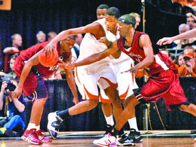 
Longhorns' Kevin Durant, center, is mobbed by the New Mexico State defense in the first half in Spokane. 
 (Brian Plonka / The Spokesman-Review)