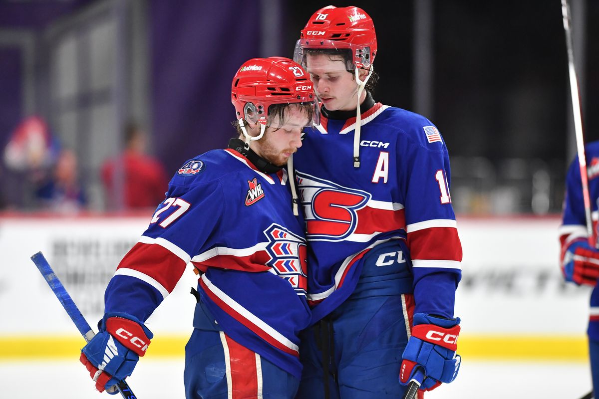 Spokane Chiefs center Berkly Catton (27) is embraced by defenseman Will McIsaac (18) after they lost to the Medicine Hat Tigers in Game 5 of the Western Hockey League Championship on Friday, May. 16, 2025, at Spokane Arena in Spokane, Wash. Medicine Hat won 4-2.  (Tyler Tjomsland/The Spokesman-Review)