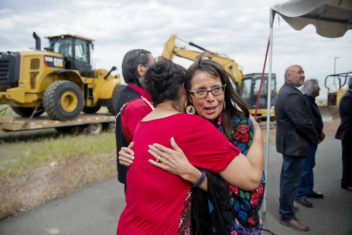 Spokane Tribal Business Council chair Carol Evans, center, smiles as she hugs Norah RedFox BrownEagle after the 2016 celebration of the tribe getting final approval from Gov. Jay Inslee for the tribe