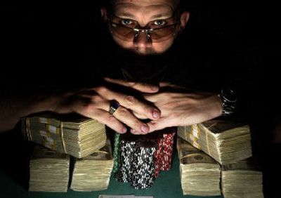 
Liberty Lake's Bryant King shows off his king's ransom – a pile of money exceeding $300,000 that he earned by placing 21st at the World Series of Poker in Las Vegas. 
 (Jed Conklin / The Spokesman-Review)