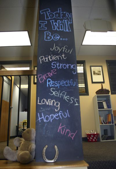 A chalkboard-painted column is displayed at the Resiliency Center in Newtown, Conn. Founded after the 2012 Sandy Hook Elementary shootings, the center offers the community mental and emotional health programs that include art, music and play therapy. (Associated Press)