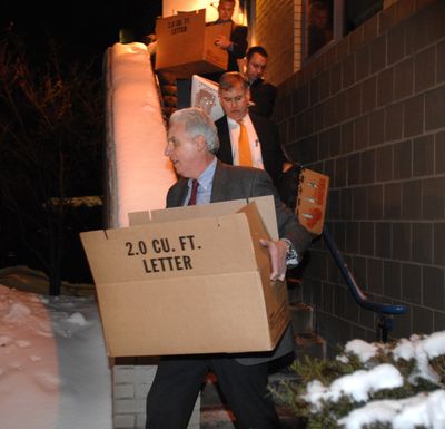 FBI agents carry boxes out of an apartment building in Cambridge, Mass., on Wednesday after searching the home of James Lewis, who was linked to fatal Tylenol poisonings in 1982.  (Associated Press / The Spokesman-Review)