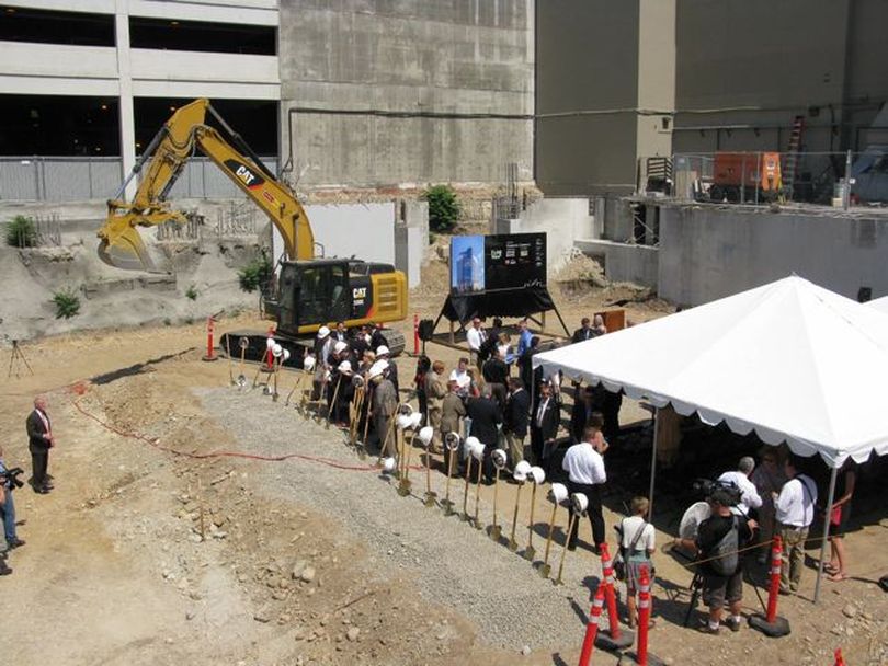 Dignitaries mill about after ground was broken Thursday for a new office tower to rise from the long vacant 