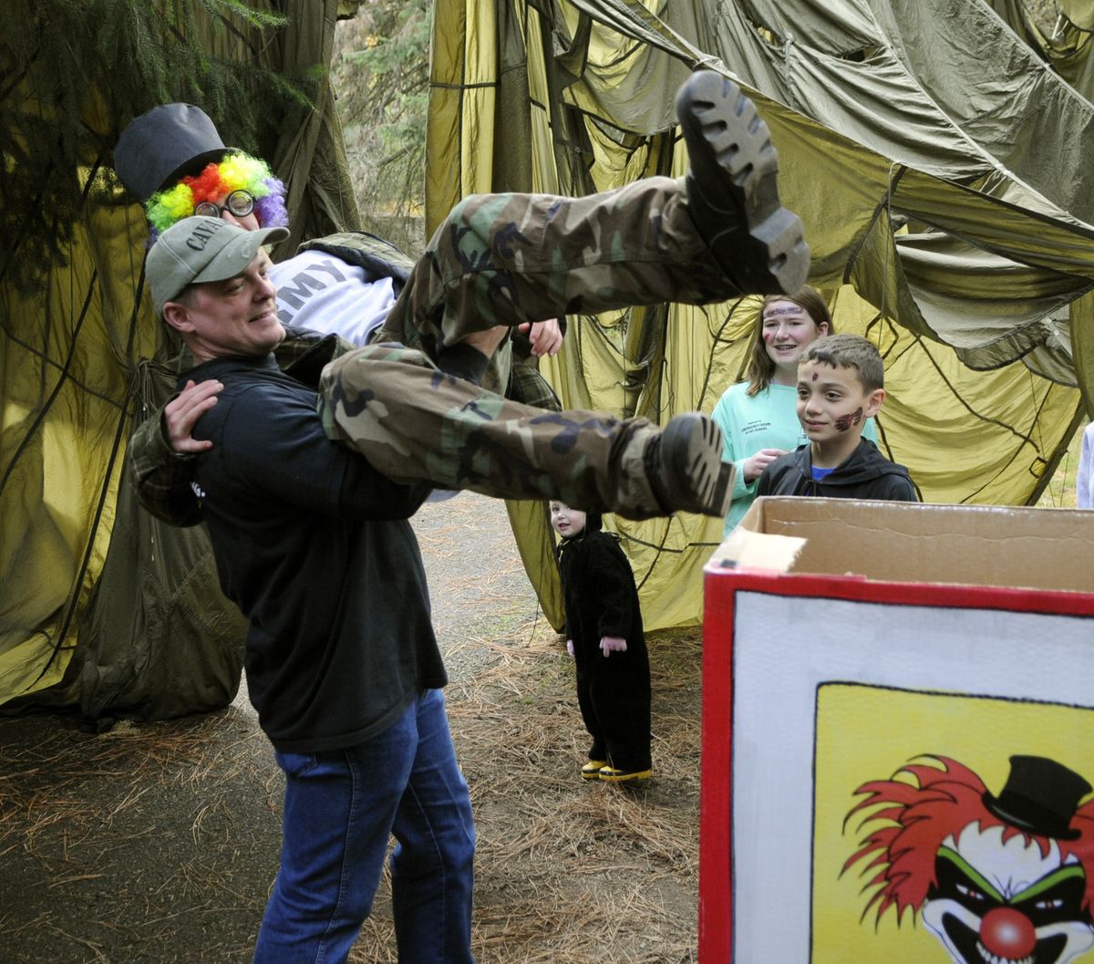 Ron Tanner, 38, lifts his son Timothy Tanner, 16, into the clown box as Boy Scouts, Explorer and Venturing troops prepare for the Inland Northwest Boy Scouts Trail of Terror on Saturday at Dishman Hills Natural Area. (Dan Pelle)