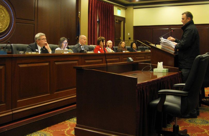Greg Pruett of the Idaho Second Amendment Alliance, with a stack of petitions, addresses the Senate State Affairs Committee on Monday morning (Betsy Z. Russell)