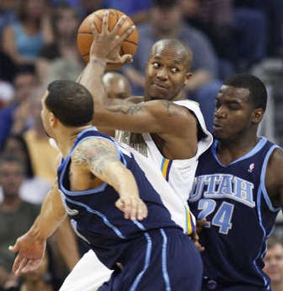 
Hornets' David West is trapped by Jazz's Deron Williams, left, and Paul Millsap. Associated Press
 (Associated Press / The Spokesman-Review)