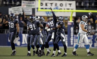 
Seahawks safety Michael Boulware points skyward after intercepting a Jake Delhomme pass during the third quarter of Seattle's NFC championship game victory. Delhomme was intercepted three times. 
 (Associated Press / The Spokesman-Review)