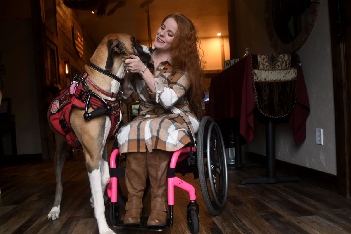 Ms. Wheelchair Idaho Devyn Burdett pets her service dog Ali on Nov. 23. Friends of hers have set up a GoFundMe for her to be able to buy an adaptable vehicle.  (Kathy Plonka/The Spokesman-Review)