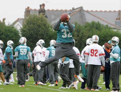 
Miami Dolphins safety Jason Allen jumps for the ball during a team training session Friday in London. Associated Press
 (Associated Press / The Spokesman-Review)