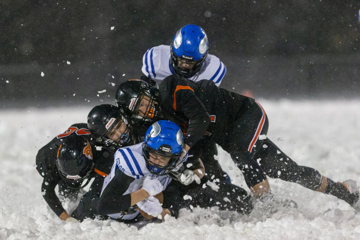 Coeur d’Alene wide receiver Cameren Cope plows through a group of Post Falls defenders during Friday’s key matchup in Post Falls.  (Cheryl Nichols/For The Spokesman-Review)