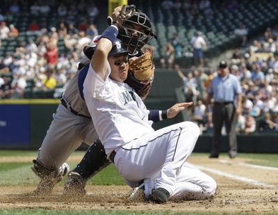 Seattle Mariners catcher Kenji Johjima is tagged out at the plate by Toronto Blue Jays catcher Rod Barajas in the second inning Wednesday, July 29, 2009, at Safeco Field in Seattle. The Mariners beat the Jays 3-2. (Associated Press)