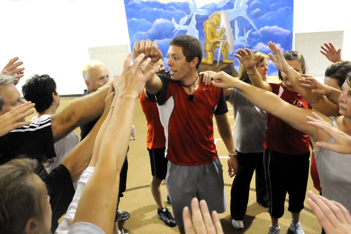 Trainer Ryan Hite, center, brings his students together at the end of the session last week for a sports team-like break at Knox Presbyterian Church in Spokane. (Jesse Tinsley / The Spokesman-Review)
