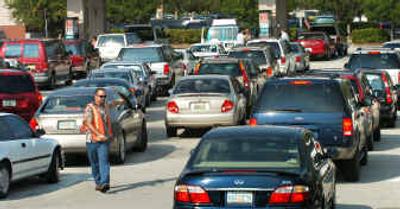 
Gas supervisor Ralph Pujol directs cars in line at the Costco store in Altamonte Springs, Fla., Friday as drivers wait in the long lines for gas in preparation for the possible strike of Hurricane Jeanne over the weekend 
 (Associated Press / The Spokesman-Review)