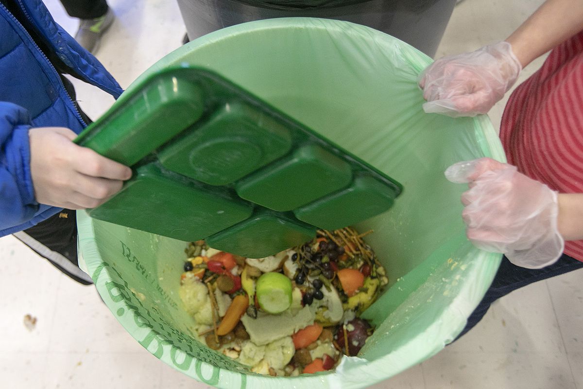 Students discard food at the end of their lunch period on Jan. 15 as part of a lunch waste composting program at an elementary school in Connecticut.  (Dave Zajac)