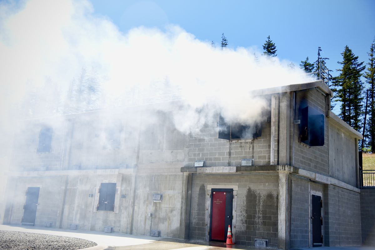 Smoke plumes during a test fire in one of the two newly built burn buildings at the Washington State Patrol Fire Training Academy on Friday near North Bend, Washington.  (Ellen Dennis / The Spokesman-Review)
