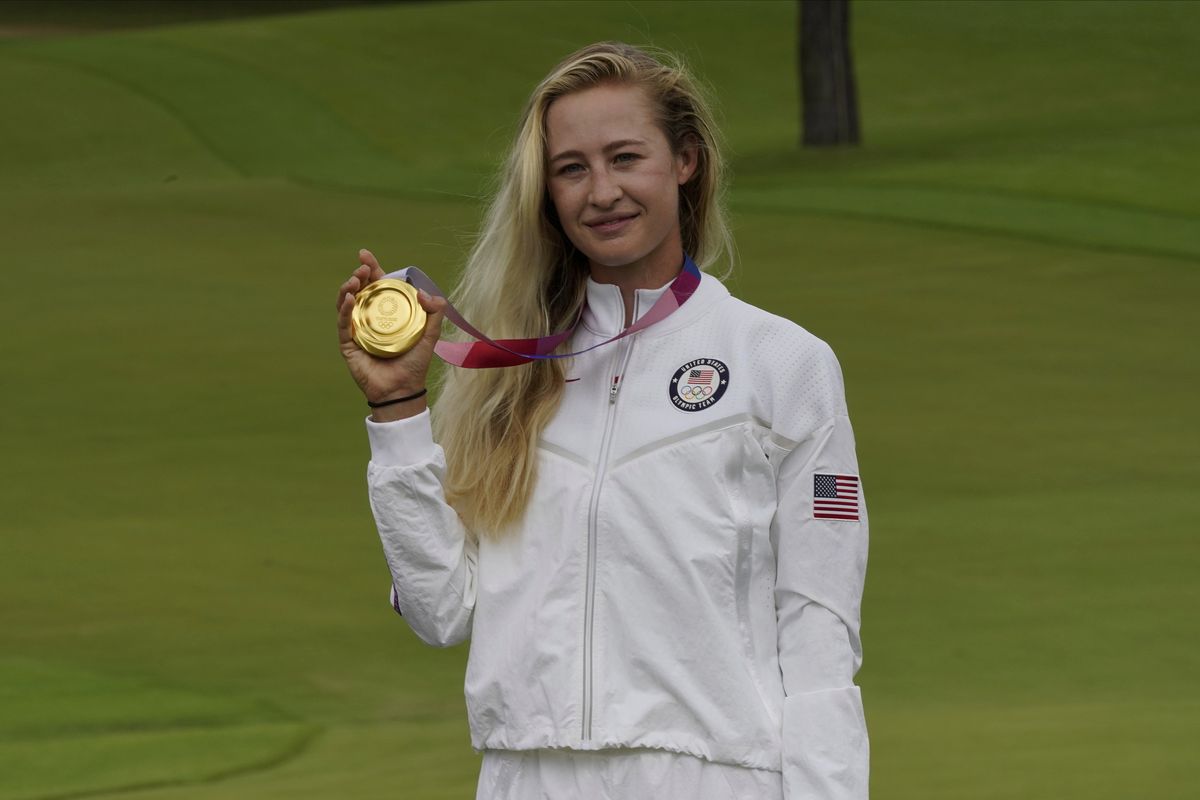 Nelly Korda, of the United States, poses with her gold medal, won in the women