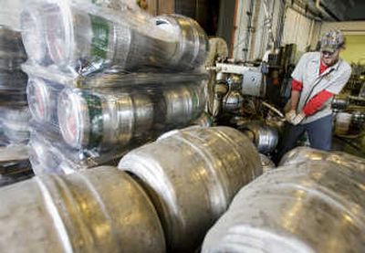 
Chad Scheridan washes out  empty kegs at the Lakefront Brewery in Milwaukee on Thursday. Associated Press
 (Associated Press / The Spokesman-Review)