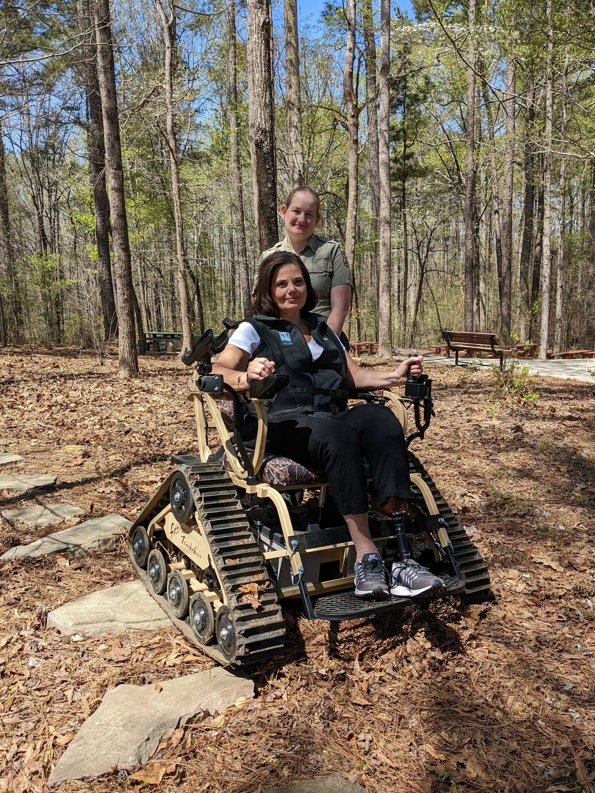 Melanie Dunn and park ranger Leslie Mobley with the all-terrain track chair.  (Georgia Department of Natural Resources)