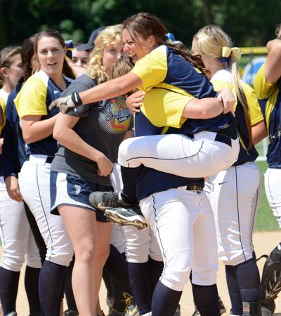 Center fielder Shalaina Duford is scooped up by teammate Lexi Miller as the Sasquatch celebrate their NWAC championship.