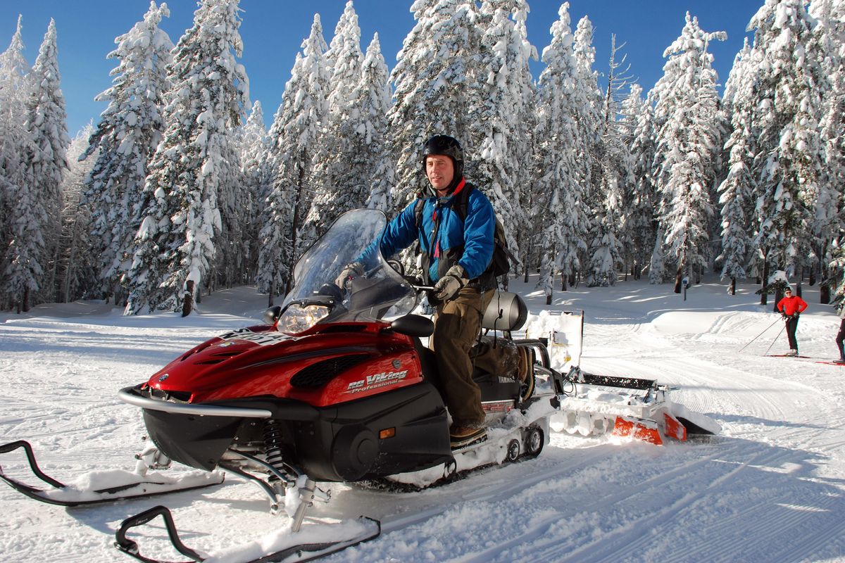 Mike Aho takes his turn on the snowmobile groomer to touch up the cross-country skiing trails at Mount Spokane. (Rich Landers)