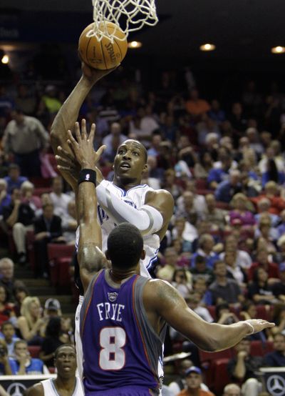 Orlando Magic center Dwight Howard goes up for a shot over Phoenix Suns center Channing Frye Wednesday.  (Associated Press / The Spokesman-Review)