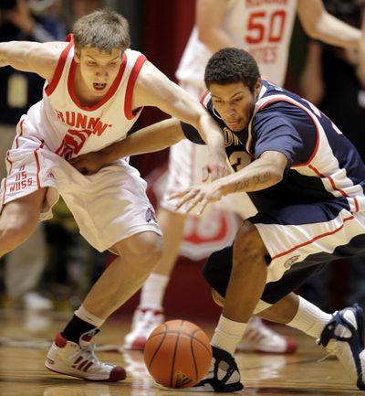 Gonzaga guard Steven Gray, right, and Utah guard Luka Drka, left, look to chase down a loose ball during the first half. (Associated Press)