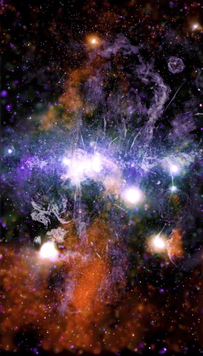 This false-color X-ray and radio frequency image shows threads of superheated gas and magnetic fields at the center of the Milky Way.  (HOGP)