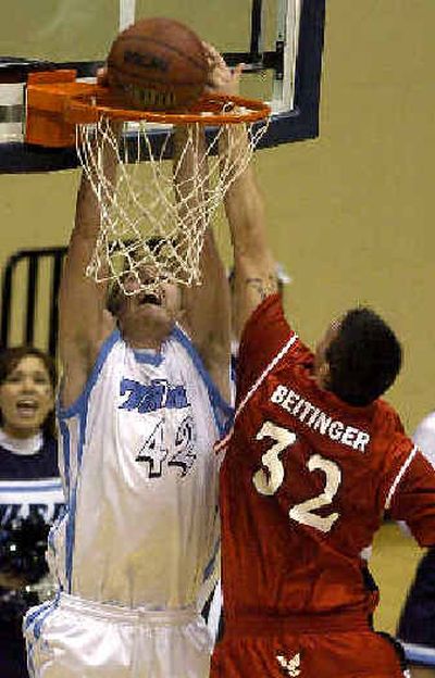 
Nick Lewis dunks on Jake Beitinger. 
 (Associated Press / The Spokesman-Review)