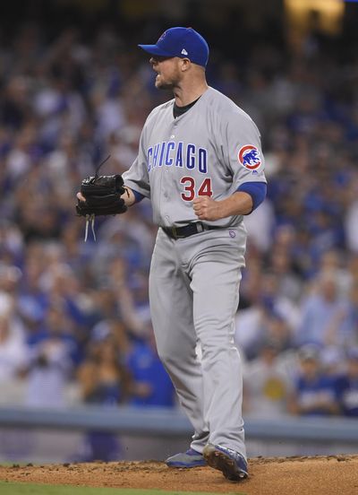 Chicago Cubs starting pitcher Jon Lester is outstanding throwing to home plate, but throws to first base are another matter. (Mark J. Terrill / Associated Press)