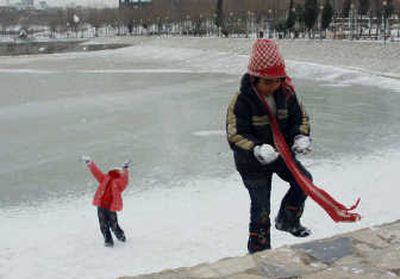 
Iraqi girls enjoy playing in snow in Sulaimaniyah, 160 miles northeast of Baghdad, on Friday. Baghdad residents saw snow for the first time in memory Friday.  Associated Press
 (Associated Press / The Spokesman-Review)