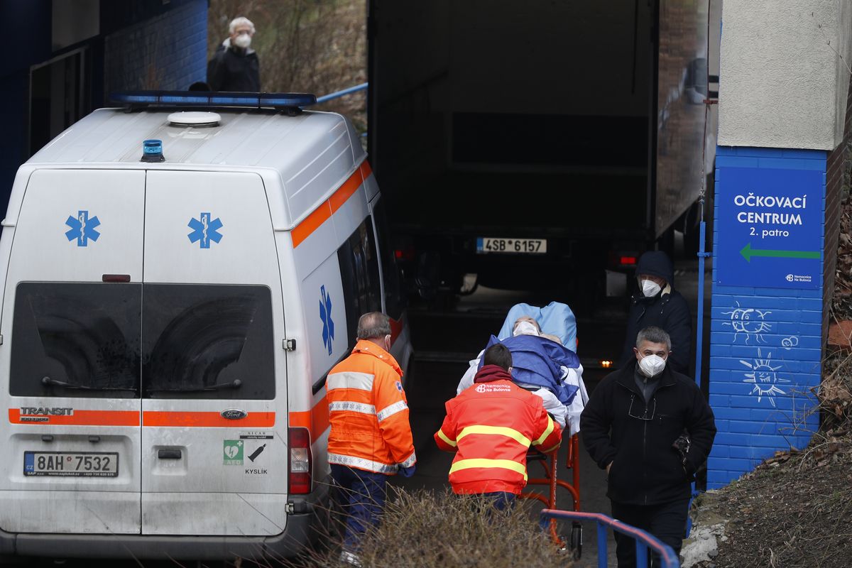 Healthcare workers move a patient to the infectious ward of the Bulovka hospital in Prague, Czech Republic, Wednesday, Feb. 24, 2021. The Czech prime minister Andrej Babis said the pandemic situation in one of the hardest-hit country in the European Union, is "extremely serious" and his government will have to impose more restrictive measures to slow down the spread of the coronavirus.  (Petr David Josek)