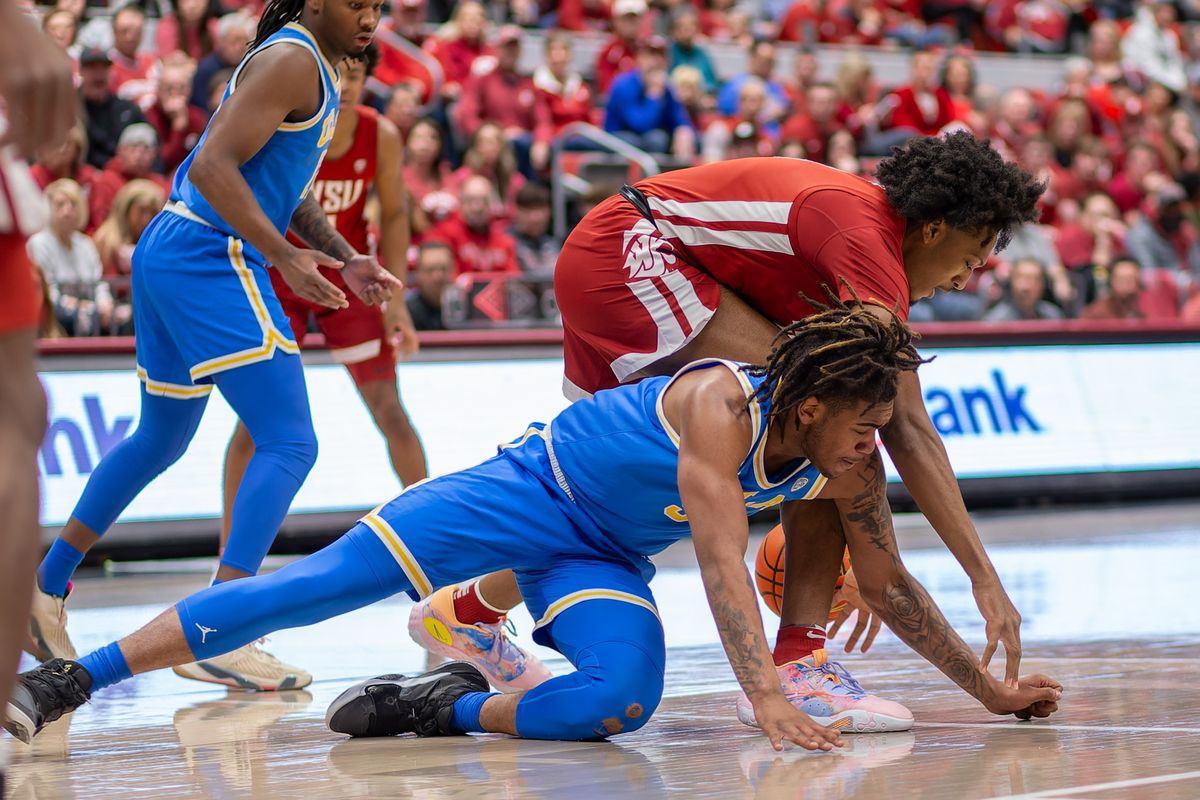 Washington State forward Isaac Jones and UCLA guard/forward Brandon Williams reach for a loose ball in the first half on Saturday, March 2, 2024, at Beasley Coliseum in Pullman.  (Geoff Crimmins/For The Spokesman-Review)