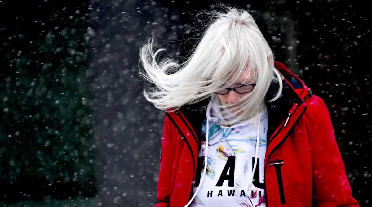 Maggie Kemp braves the frigid wind as she makes her way to her car in the parking lot at Fred Meyer in Coeur d’Alene on Thursday.  (Kathy Plonka/The Spokesman-Review)