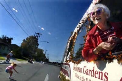 
Sally Barron tosses candy from the Holman Gardens van during the Valleyfest parade on University Avenue on Saturday. The event started with a parade and moved to Maribeau Park for food, music and games. 
 (Jed Conklin / The Spokesman-Review)